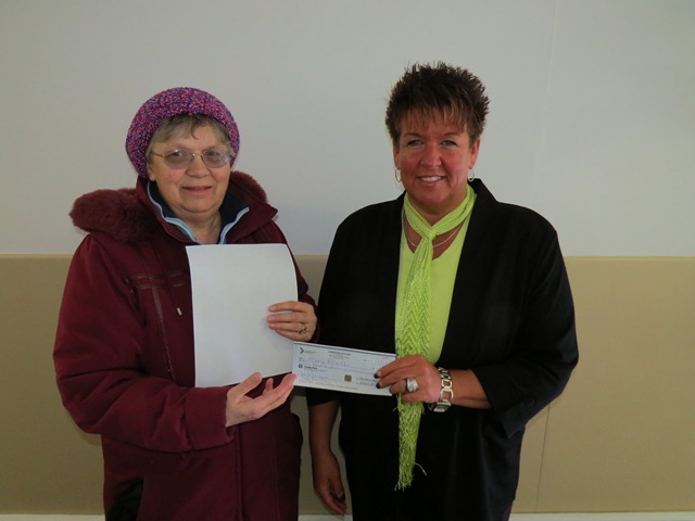 Kim Harvey, Residential Supervisor at Community Living Kirkland Lake presents Helen Rozich with a cheque for $500.  Mrs. Rozich was the big winner in the draw that awarded $2000 in prizes to 22 lucky winners in January.